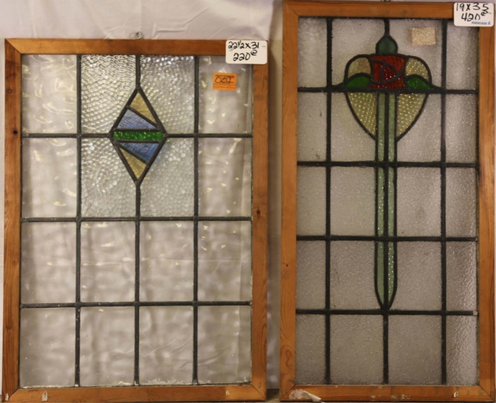 TWO ANTIQUE CONTINENTAL STAINED GLASS PANELS: Two antique Continental stained glass panels, one with floral medallion and the other with geometric medallion and textured panel accents. Approximate dimensions: h. 35", w. 19" Disclaimer: This is an