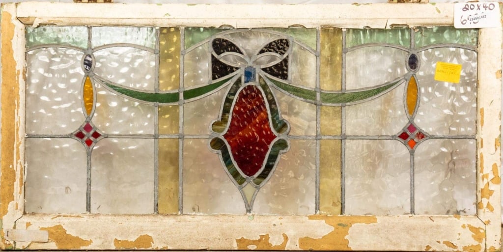 FRENCH ART NOUVEAU STAINED GLASS PANEL: French Art Nouveau stained glass panel with a bow and ribbon motif and wispy glass accents. Approximate dimensions: h. 20", w. 40" Disclaimer: This is an online court ordered bankruptcy sale. Particip