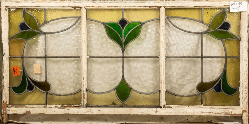 FRENCH ART NOUVEAU STAINED GLASS PANEL: French Art Nouveau stained glass panel with a botanical motif. Approximate dimensions: h. 25", w. 53" Disclaimer: This is an online court ordered bankruptcy sale. Participating bidders must have a cre