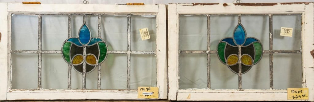 PAIR OF FRENCH ART NOUVEAU STAINED GLASS PANEL: Pair of French Art Nouveau stained glass panels with heart-shaped floral medallion. Approximate dimensions: h. 17", w. 29" Disclaimer: This is an online court ordered bankruptcy sale. Participating bi