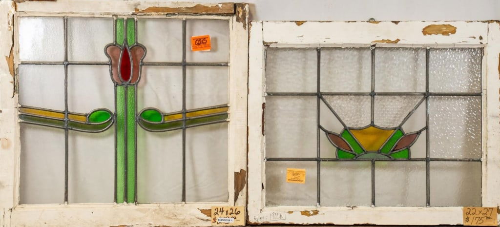 TWO CONTINENTAL STAINED GLASS PANELS: Two Continental stained glass panels with multicolored accents. Approximate dimensions: h. 24", w. 26" Disclaimer: This is an online court ordered bankruptcy sale. Participating bidders must have a cr