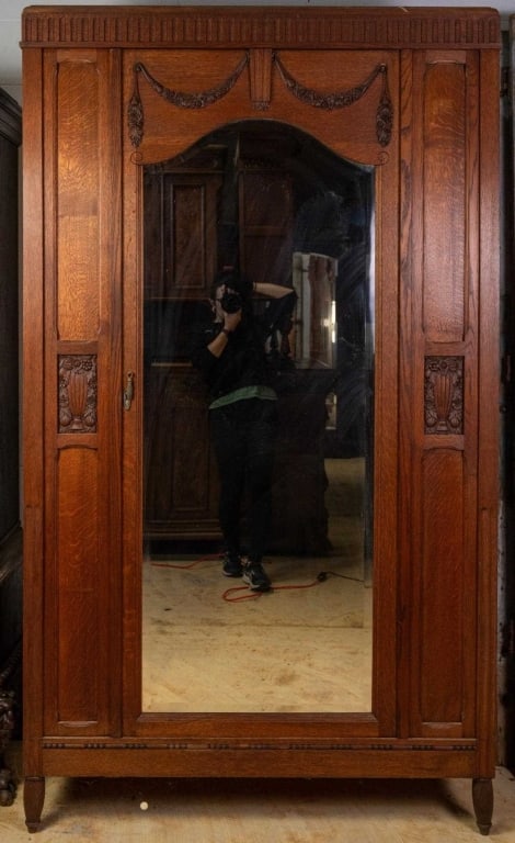 FRENCH ART NOUVEAU ARMOIRE: French Art Nouveau armoire with beveled mirror, inset carved panels, and floral carved appliqués. Approximate dimensions: h. 82.5", w. 48", d. 23.75" Disclaimer: This is an online court ordered bankr