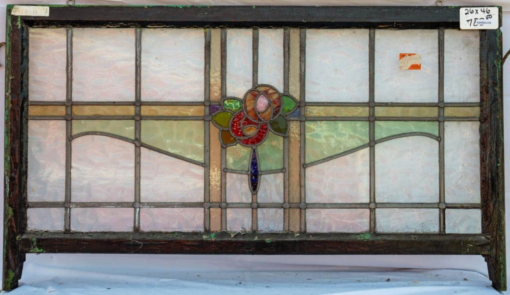 FRENCH ART NOUVEAU STAINED GLASS PANEL: French Art Nouveau stained glass panel with a central floral medallion and amber and green leaded stained glass panels. Approximate dimensions: h. 26", w. 46" Disclaimer: This is an online court order