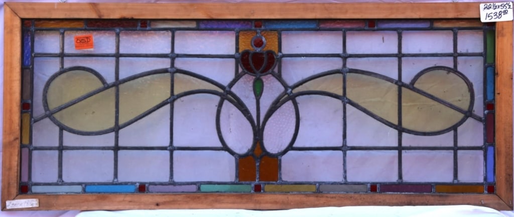 ANTIQUE STAINED GLASS WINDOW: Antique stained glass window. Approximate dimensions: h. 22.5", w. 55.5" Disclaimer: This is an online court ordered bankruptcy sale. Participating bidders must have a credit card on file with Live Au