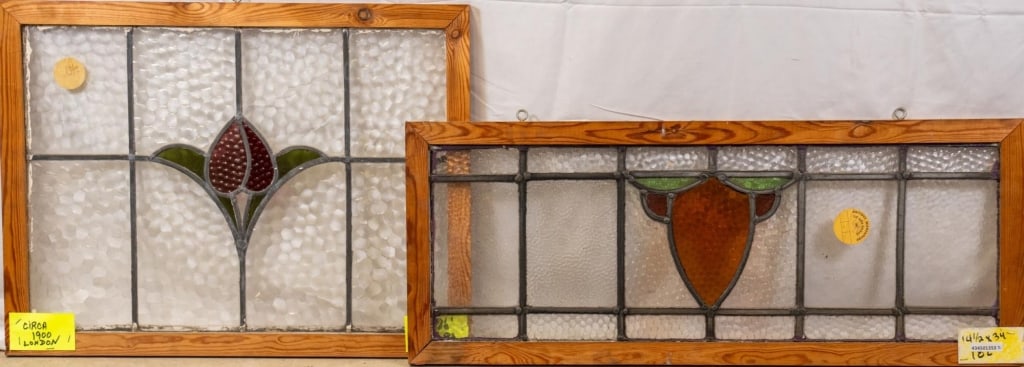 TWO ENGLISH STAINED GLASS PANELS: Two English stained glass panels, one with a floral medallion and the other with a shield-shaped medallion. Approximate dimensions: h. 20", w. 26" Disclaimer: This is an online court ordered bankruptc