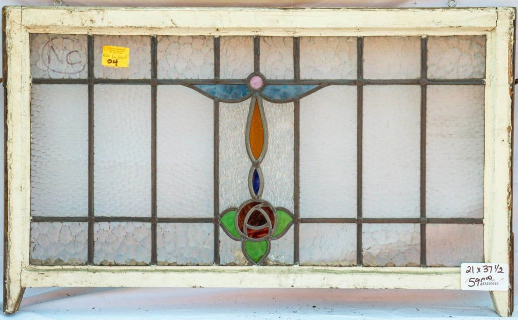 FRENCH ART NOUVEAU STAINED GLASS PANEL: French Art Nouveau stained glass panel with a floral motif set within colorless textured leaded glass panels. Approximate dimensions: h. 21", w. 37.5" Disclaimer: This is an online court ordered bankr