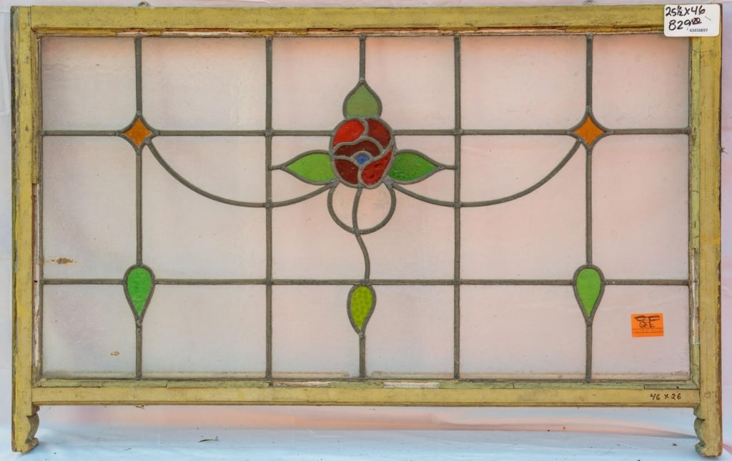 FRENCH ART NOUVEAU STAINED GLASS PANEL: French Art Nouveau stained glass panel with a red rose medallion in stained glass, set within colorless leaded glass panels. Approximate dimensions: h. 25", w. 46" Disclaimer: This is an online court