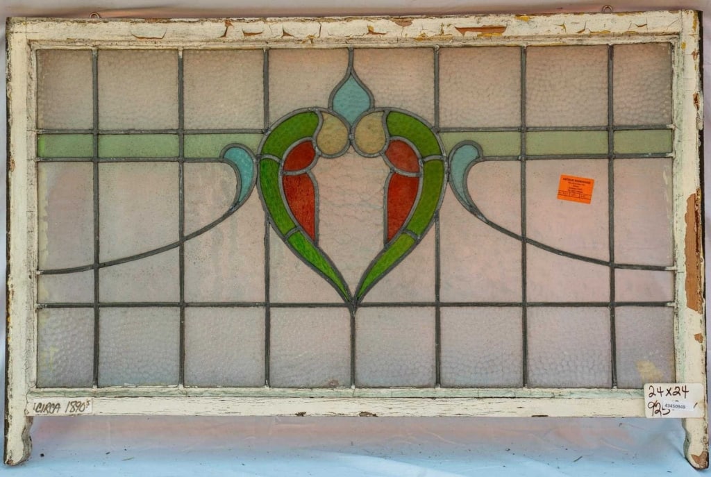 FRENCH ART NOUVEAU STAINED GLASS PANEL: French Art Nouveau stained glass panel with a heart-shaped stained glass medallion. Approximate dimensions: h. 27.5", w. 42" Disclaimer: This is an online court ordered bankruptcy sale. Participating
