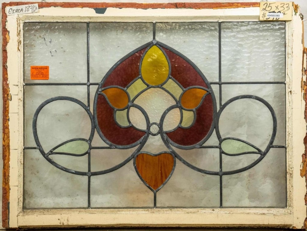 FRENCH ART NOUVEAU STAINED GLASS PANEL: French Art Nouveau stained glass panel with heart-shaped floral medallion and leaf accents. Approximate dimensions: h. 25", w. 33" Disclaimer: This is an online court ordered bankruptcy sale. Particip