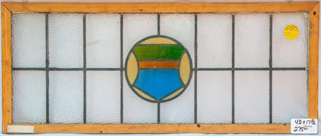 IRISH STAINED GLASS PANEL: Irish stained glass panel with a shield medallion. Approximate dimensions: h. 17.5", w. 42" Disclaimer: This is an online court ordered bankruptcy sale. Participating bidders must have a credit card o