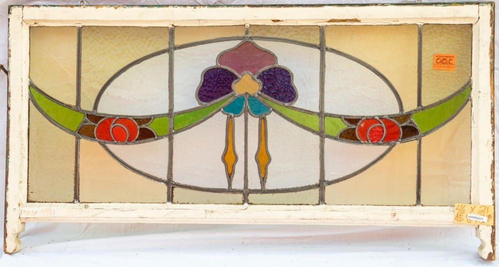 FRENCH ART NOUVEAU STAINED GLASS PANEL: French Art Nouveau stained glass panel with a floral and ribbon motif. Approximate dimensions: h. 21", w. 46" Disclaimer: This is an online court ordered bankruptcy sale. Participating bidders must ha