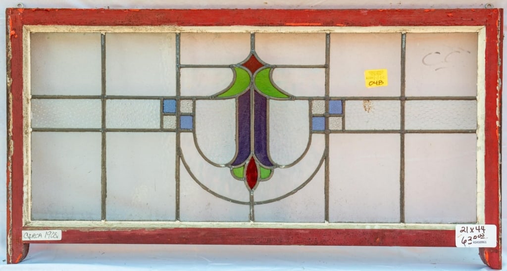 FRENCH ART NOUVEAU STAINED GLASS PANEL: French Art Nouveau stained glass panel with colorless textured leaded glass panels and green, red, and purple stained glass details. Approximate dimensions: h. 21", w. 44" Disclaimer: This is an onlin
