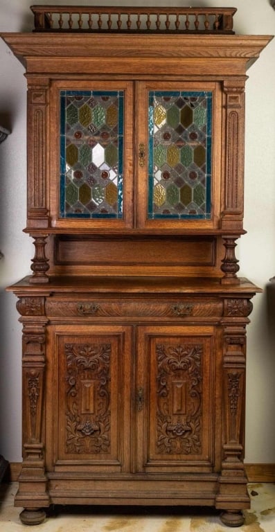 FRENCH RENAISSANCE REVIVAL STAINED GLASS VITRINE C: French Renaissance Revival stained glass vitrine cabinet with carved gallery and inset carved panels. Approximate dimensions: h. 89", w. 48", d. 23" Disclaimer: This is an online court ordered bankrup