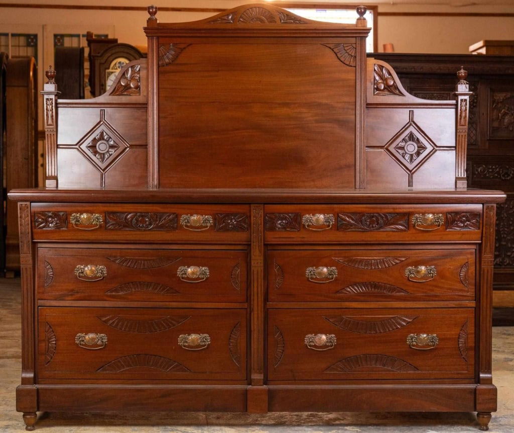 ENGLISH MAHOGANY SIDEBOARD: English mahogany sideboard with tall backsplash, turned legs, carved appliqués, and Art Nouveau-inspired details. Approximate dimensions: h. 66", w. 73", d. 22.5" Disclaimer: This is an online court