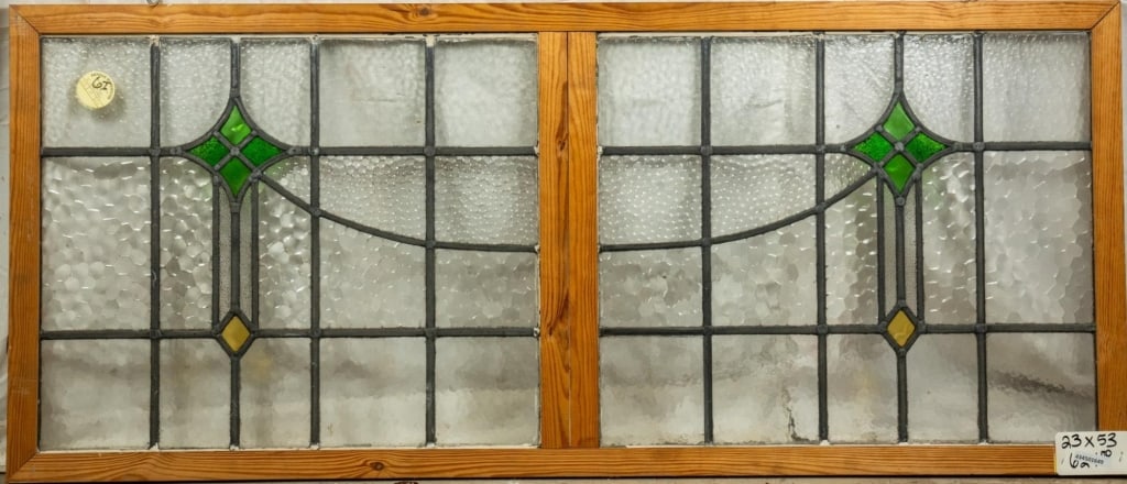 ANTIQUE CONTINENTAL STAINED GLASS PANEL: Antique Continental stained glass panel with green and amber accents. Approximate dimensions: h. 23", w. 53" Disclaimer: This is an online court ordered bankruptcy sale. Participating bidders must hav