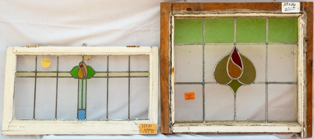TWO FRENCH STAINED GLASS PANELS: Two French stained glass panels with amber, green, and red floral medallions. Approximate dimensions: h. 26", w. 29" Disclaimer: This is an online court ordered bankruptcy sale. Participating bidders