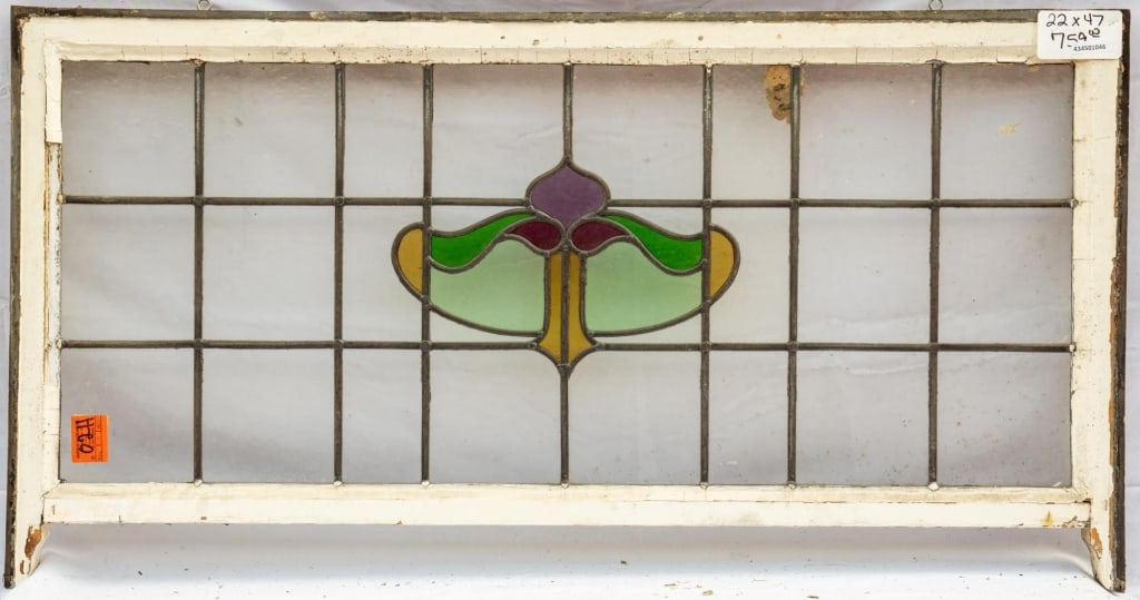 FRENCH ART NOUVEAU STAINED GLASS PANEL: French Art Nouveau stained glass panel with an abstract central multicolored stained glass medallion. Approximate dimensions: h. 22", w. 47" Disclaimer: This is an online court ordered bankruptcy sale