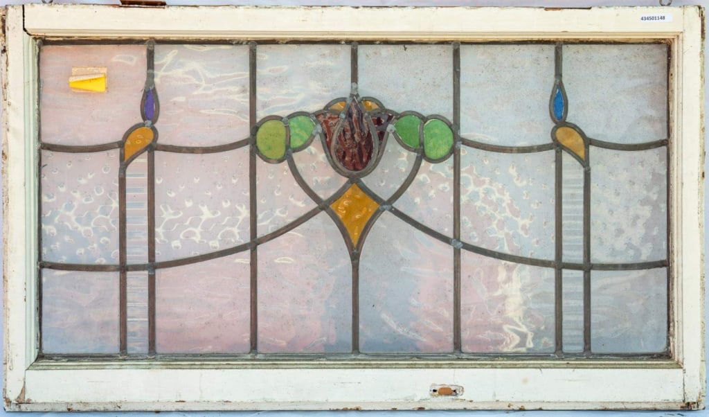 FRENCH ART NOUVEAU STAINED GLASS PANEL: French Art Nouveau stained glass panel with a central red tulip medallion surrounded by green, blue, and yellow stained glass accents. Approximate dimensions: h. 22.5", w. 39" Disclaimer: This is an o