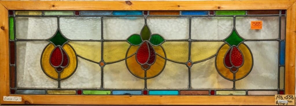 FRENCH ART NOUVEAU STAINED JEWELED GLASS PANEL: French Art Nouveau stained jeweled glass panel with a central floral medallion, two symmetrical floral elements, and jeweled details. Approximate dimensions: h. 19.5", w. 55.5" Disclaimer: This is an 