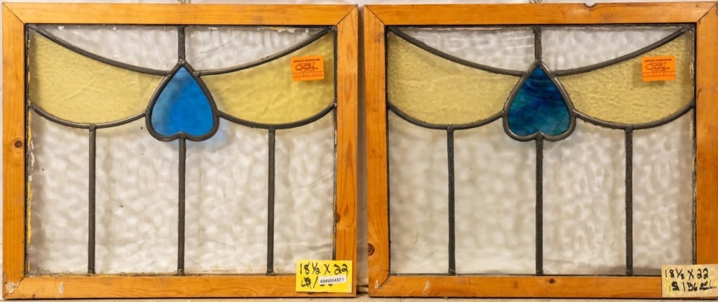 TWO FRENCH ART NOUVEAU STAINED GLASS PANELS: Two French Art Nouveau stained glass panels with blue heart-shaped medallions and amber glass accents. Approximate dimensions: h. 18.5", w. 22" Disclaimer: This is an online court ordered bankruptcy s