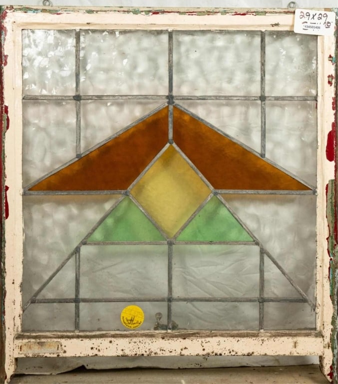 ENGLISH ART DECO STAINED GLASS PANEL: English Art Deco stained glass panel with geometric accents in amber, green and yellow. Approximate dimensions: h. 29", w. 29" Disclaimer: This is an online court ordered bankruptcy sale. Participatin