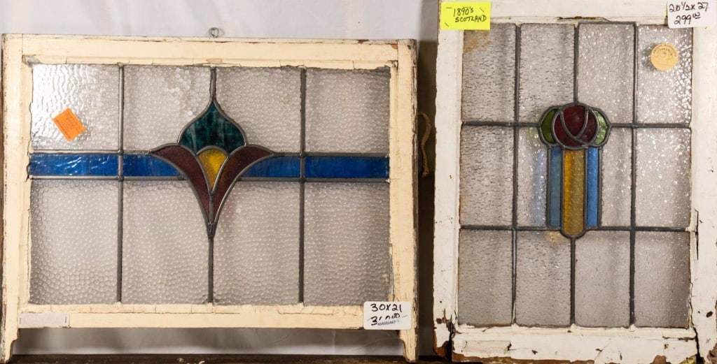 TWO ANTIQUE FRENCH STAINED GLASS PANELS: Two antique French stained glass panels, one with a floral medallion, the other with a floral motif and wispy glass accent. Approximate dimensions: h. 21", w. 30" Disclaimer: This is an online court o