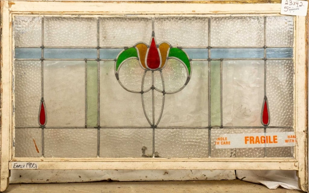 FRENCH ART NOUVEAU STAINED GLASS PANEL: French Art Nouveau stained glass panel with a floral medallion and red drop-shaped accents. Approximate dimensions: h. 23", w. 42" Disclaimer: This is an online court ordered bankruptcy sale. Particip