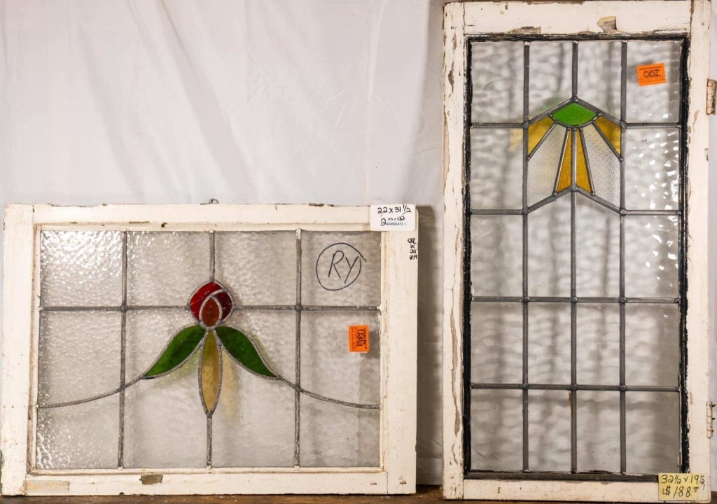TWO FRENCH STAINED GLASS PANELS: Two French stained glass panels with floral and geometric motifs. Approximate dimensions: h. 22", w. 31.5" Disclaimer: This is an online court ordered bankruptcy sale. Participating bidders must have