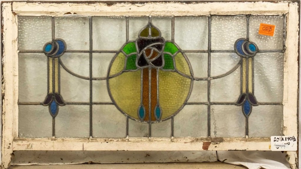 FRENCH ART NOUVEAU STAINED GLASS PANEL: French Art Nouveau stained glass panel with a floral medallion and symmetrical floral motif accents on the sides. Approximate dimensions: h. 20.5", w. 40.5" Disclaimer: This is an online court ordered