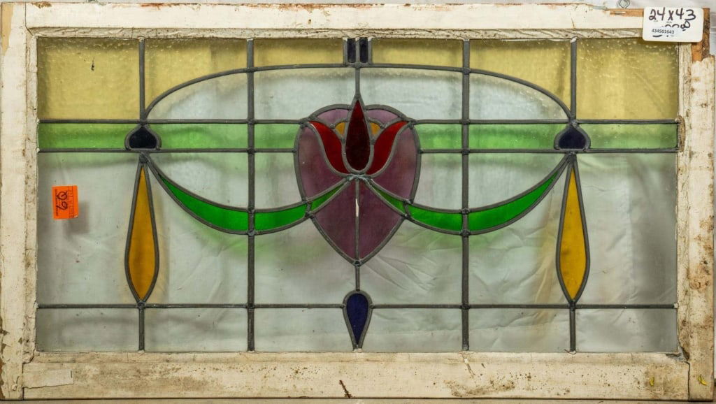 FRENCH ART NOUVEAU STAINED GLASS PANEL: French Art Nouveau stained glass panel with purple heart-shaped floral medallion and garland motif. Approximate dimensions: h. 24", w. 43" Disclaimer: This is an online court ordered bankruptcy sale.