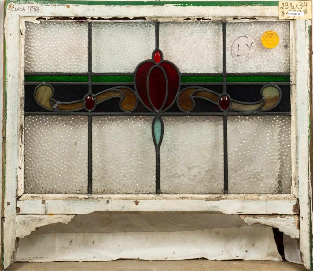 FRENCH ART NOUVEAU JEWELED STAINED GLASS PANEL: French Art Nouveau jeweled stained glass panel with a floral medallion and red jeweled details. Approximate dimensions: h. 23.5", w. 34" Disclaimer: This is an online court ordered bankruptcy sale. Pa
