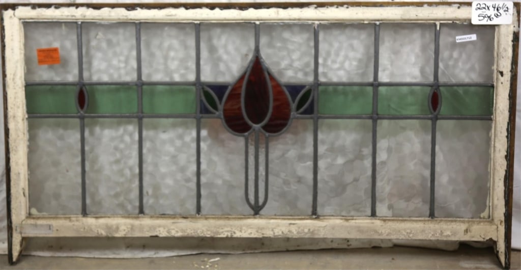 FRENCH ART NOUVEAU STAINED GLASS PANEL: French Art Nouveau stained glass panel with a floral medallion and wispy glass red petal details. Approximate dimensions: h. 22", w. 46.5" Disclaimer: This is an online court ordered bankruptcy sale.
