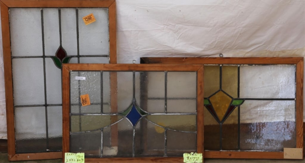 THREE IRISH STAINED GLASS PANELS: Three Irish stained glass panels with floral and geometric medallions and multicolored stained glass accents. Approximate dimensions: h. 29.5", w. 20" Disclaimer: This is an online court ordered bankr