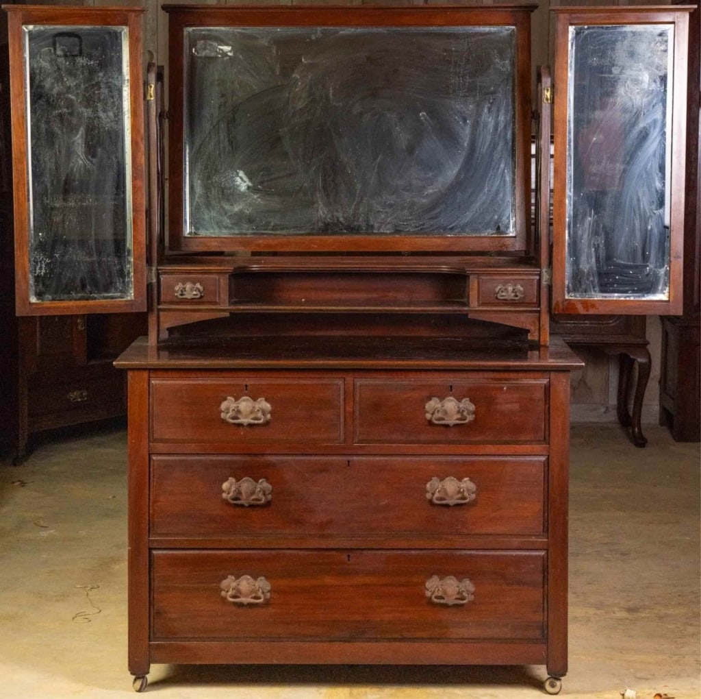 ENGLISH MAHOGANY TRIPLE MIRROR DRESSER: English mahogany triple mirror dresser with beveled mirrors, castered legs, and carved elements. Approximate dimensions: h. 64", w. 42", d. 20" Disclaimer: This is an online court ordered bankruptcy s