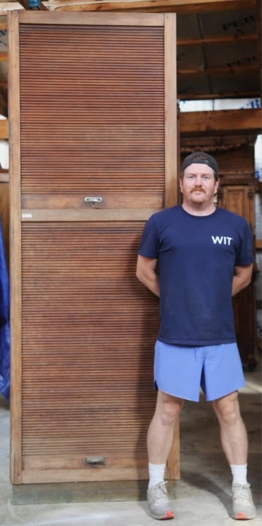 ENGLISH ART DECO TAMBOUR DOOR CABINET: English Art Deco tambour door cabinet with a hand-hammered copper base. Approximate dimensions: h. 94", w. 32.75", d. 13" Disclaimer: This is an online court ordered bankruptcy sale. Participating bid