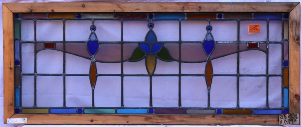 ANTIQUE STAINED GLASS WINDOW: Antique stained glass window. Approximate dimensions: h. 21.5", w. 52.5" Disclaimer: This is an online court ordered bankruptcy sale. Participating bidders must have a credit card on file with Live Au
