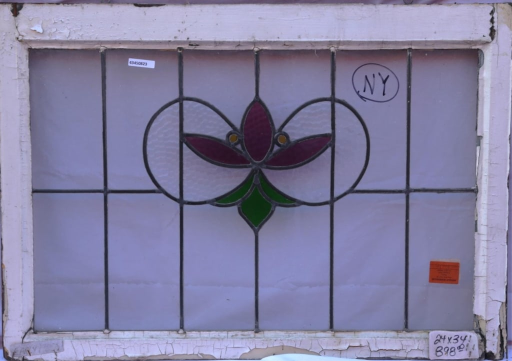 ANTIQUE STAINED GLASS WINDOW: Antique stained glass window. Approximate dimensions: h. 24", w. 34" Disclaimer: This is an online court ordered bankruptcy sale. Participating bidders must have a credit card on file with Live Auctio