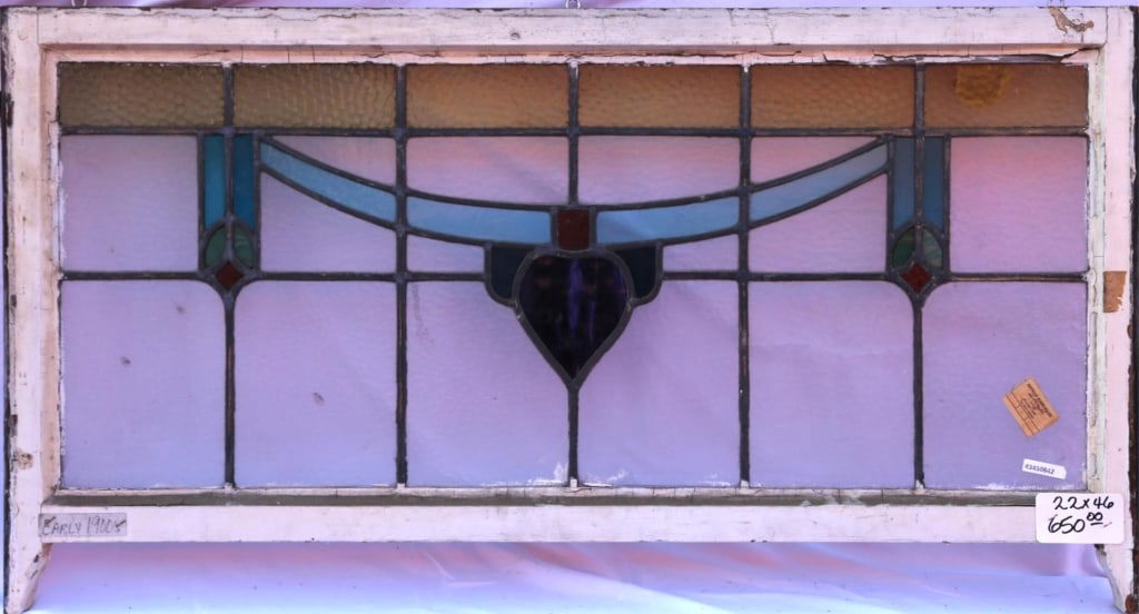 ANTIQUE STAINED GLASS WINDOW: Antique stained glass window. Approximate dimensions: h. 22", w. 46" Disclaimer: This is an online court ordered bankruptcy sale. Participating bidders must have a credit card on file with Live Auctio