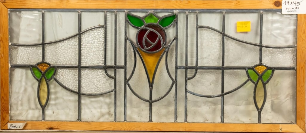 FRENCH ART NOUVEAU STAINED GLASS PANEL: French Art Nouveau stained glass panel with a rose and leaf medallion and symmetrical floral motif details. Approximate dimensions: h. 19", w. 45" Disclaimer: This is an online court ordered bankruptc