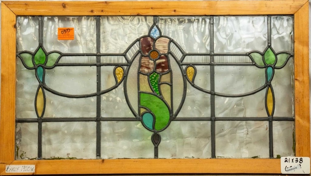 FRENCH ART NOUVEAU STAINED GLASS PANEL: French Art Nouveau stained glass panel with floral medallion and floral accents to the sides. Approximate dimensions: h. 21", w. 38" Disclaimer: This is an online court ordered bankruptcy sale. Partic