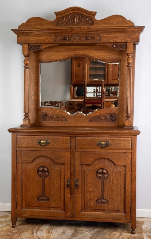 19TH C. FRENCH ART NOUVEAU BUFFET: French, 19th century. Art Nouveau buffet with carved details, beveled mirrored back, and period Art Nouveau pulls. Approximate dimensions: h. 81.5", w. 47.75", d. 18.75" Disclaimer: This is an online