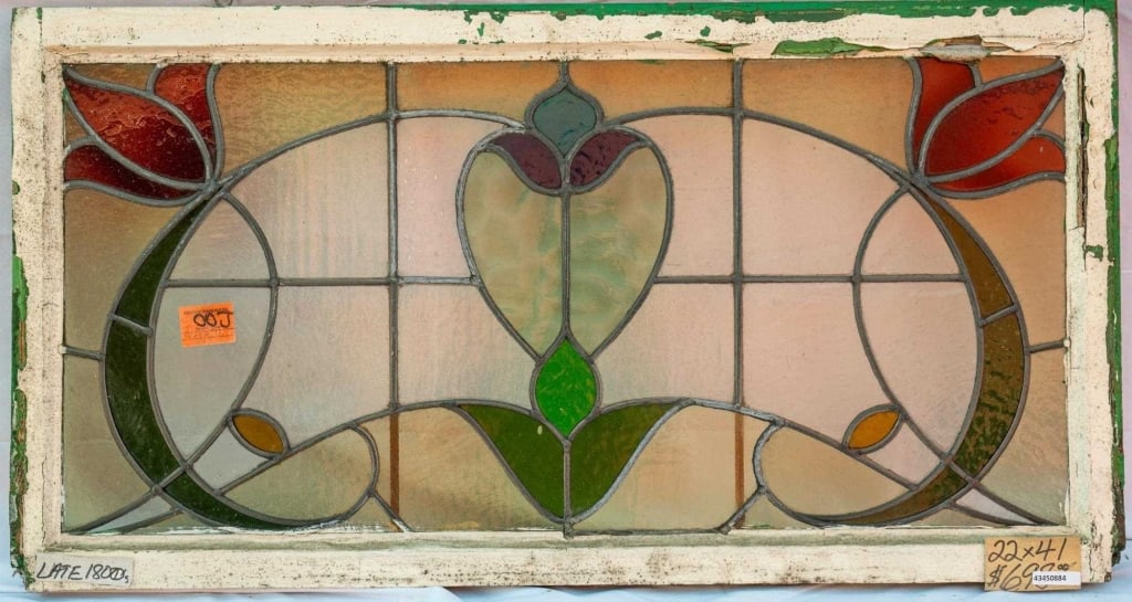 FRENCH ART NOUVEAU STAINED GLASS PANEL: French Art Nouveau stained glass panel with red floral motifs, accented with amber and green stained glass. Approximate dimensions: h. 22", w. 41" Disclaimer: This is an online court ordered bankruptc