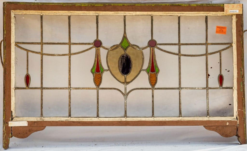 FRENCH ART NOUVEAU STAINED GLASS PANEL: French Art Nouveau stained glass panel with a heart-shaped central medallion. Approximate dimensions: h. 43.5", w. 26" Disclaimer: This is an online court ordered bankruptcy sale. Participating bidder