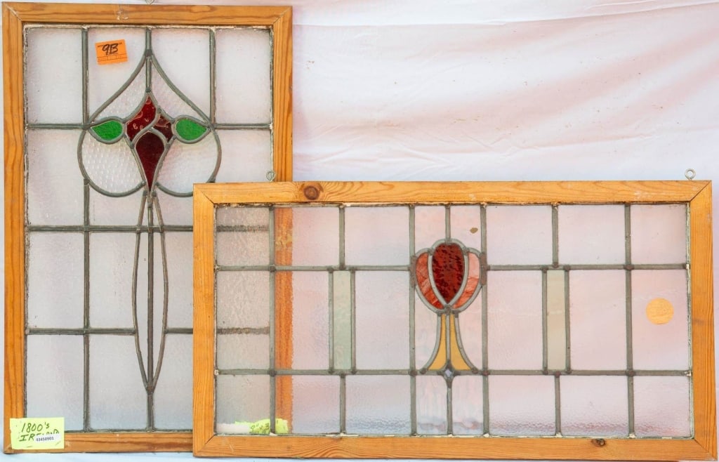 TWO FRENCH ART NOUVEAU STAINED GLASS PANELS: Two French Art Nouveau stained glass panels with a red floral motif accented with amber and green stained glass. Approximate dimensions: h. 18", w. 34" Disclaimer: This is an online court ordered bank