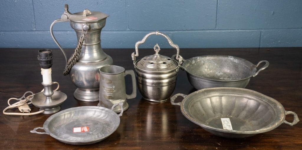 7 PEWTER TABLE ARTICLES: 7 pewter table articles, including lidded wine jug, mug, candleholder, and serving tableware. Disclaimer: This is an online court ordered bankruptcy sale. Participating bidders must have a credit card
