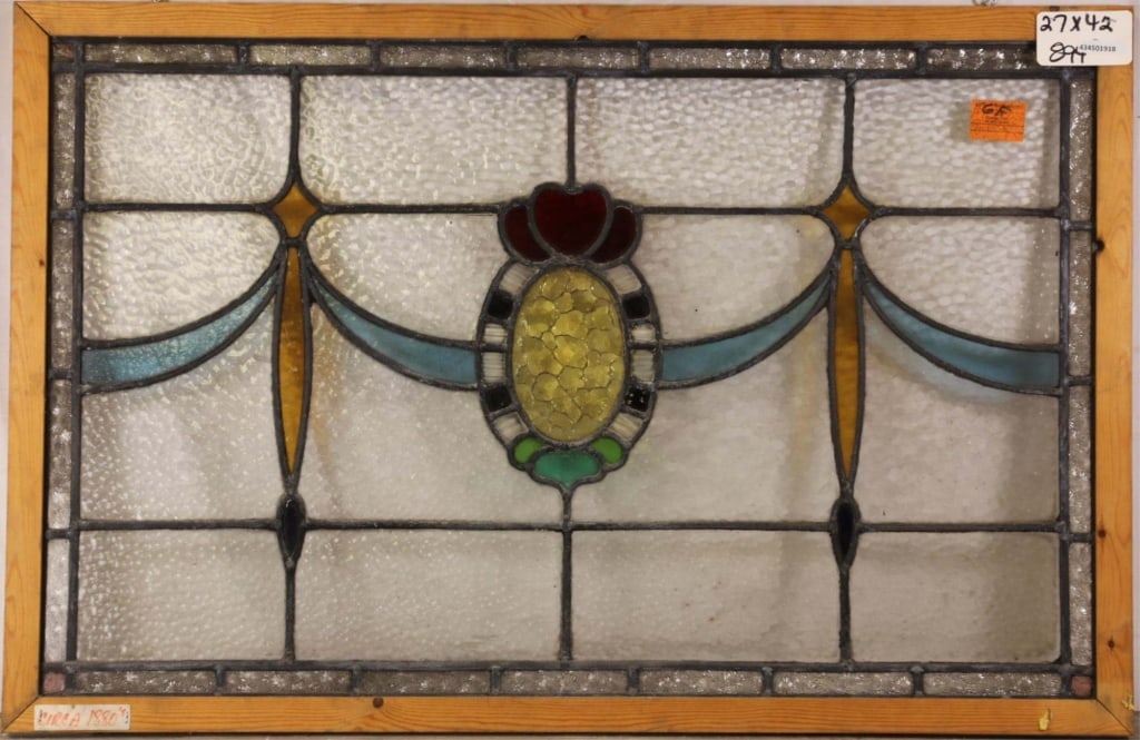 ANTIQUE CONTINENTAL STAINED GLASS PANEL: Antique Continental stained glass panel with oval medallion, textured canary yellow detail, and blue garland motif. Approximate dimensions: h. 27", w. 42" Disclaimer: This is an online court ordered b