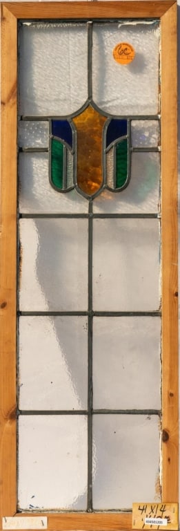 IRISH STAINED GLASS PANEL: Irish stained glass panel with a shield medallion in amber, blue, and green. Approximate dimensions: h. 41", w. 14" Disclaimer: This is an online court ordered bankruptcy sale. Participating bidders m