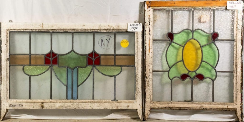 TWO CONTINENTAL STAINED GLASS PANELS: Two Continental stained glass panels with green, blue, red, and canary yellow stained glass accents. Approximate dimensions: h. 32.5", w. 26.5" Disclaimer: This is an online court ordered bankruptcy s