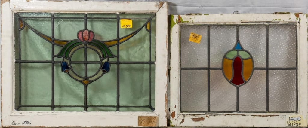TWO FRENCH STAINED GLASS PANELS: Two French stained glass panels, one with a floral wreath-shaped medallion and garland accents. Approximate dimensions: h. 22", w. 28" Disclaimer: This is an online court ordered bankruptcy sale. Part
