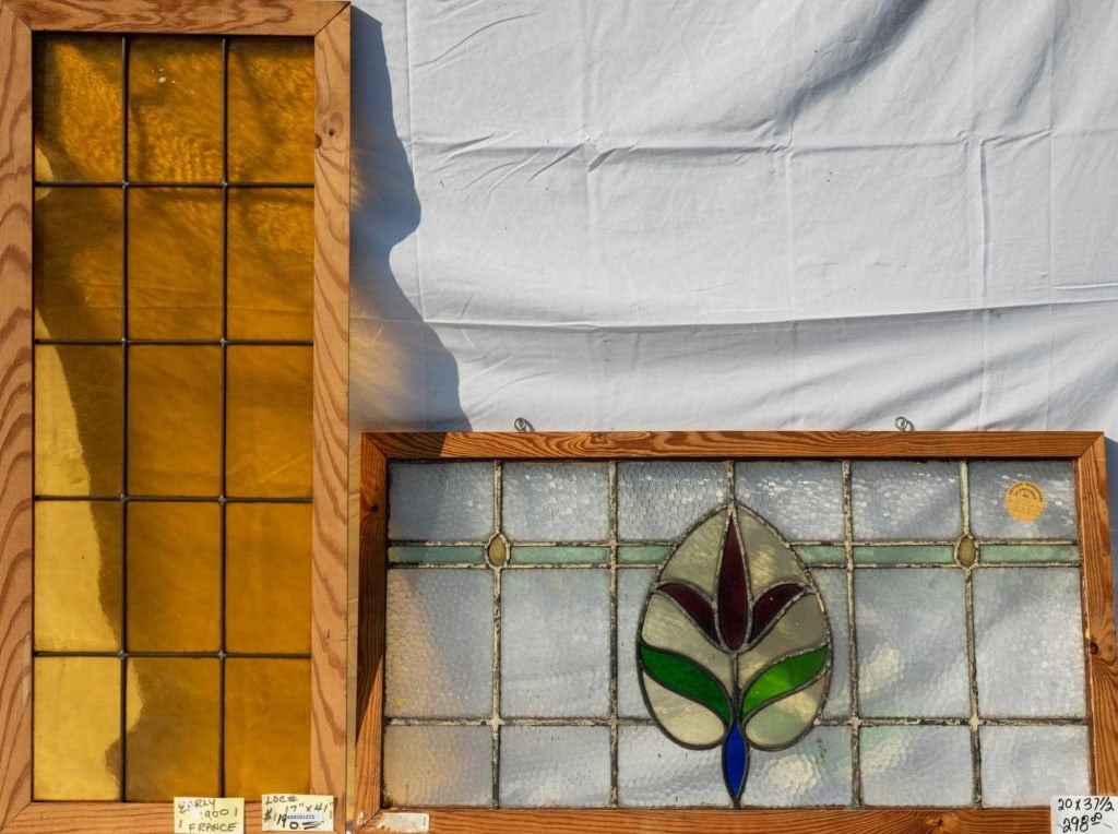 TWO FRENCH STAINED GLASS PANELS: Two French stained glass panels, one with a floral medallion and the other with amber leaded glass panels. Approximate dimensions: h. 20", w. 37.5" Disclaimer: This is an online court ordered bankrupt